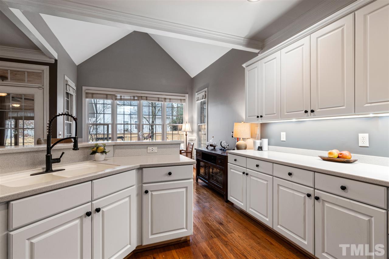 2408 Carruthers Court Raleigh, NC 27615 - Photo 10 of 30 a kitchen with white cabinets and sink
