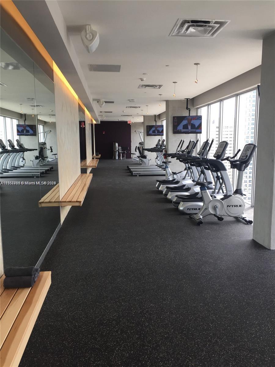 151 Southeast 1st Street, Unit 1505 Miami, FL 33131 - Photo 20 of 23 a view of a room with gym equipment