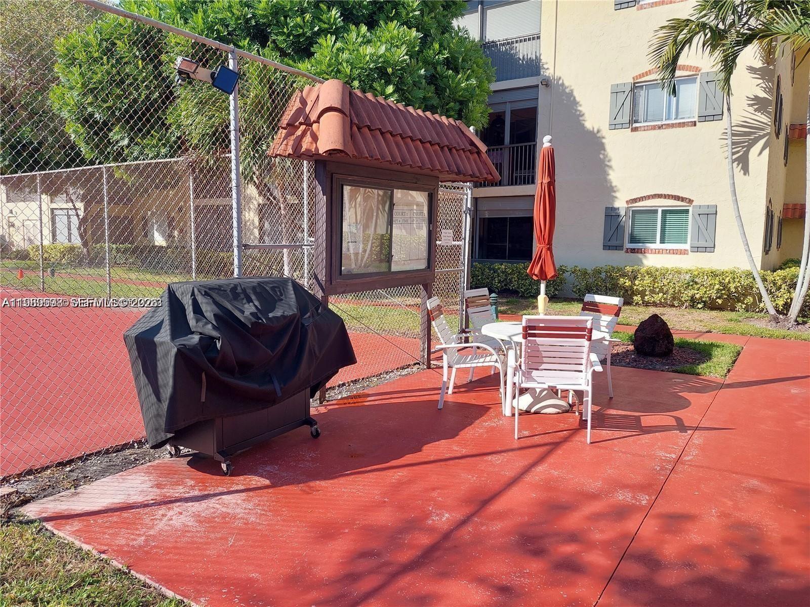 253 South Cypress Road, Unit 214 Pompano Beach, FL 33060 - Photo 21 of 25 a building outdoor space with patio furniture