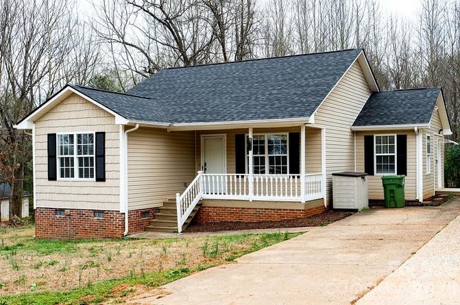 226 B Brookwood Road Belmont, NC 28012 - Photo 1 of 29 a front view of a house with a garden