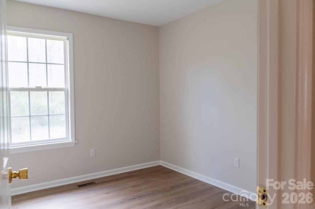 226 B Brookwood Road Belmont, NC 28012 - Photo 15 of 29 wooden floor in an empty room with a window