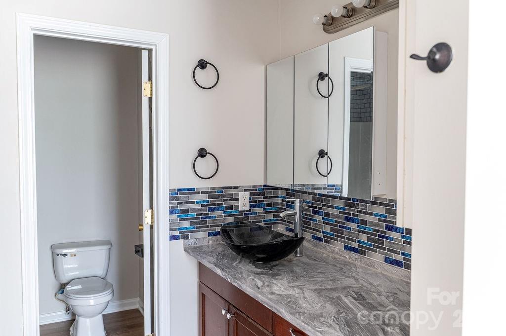 226 B Brookwood Road Belmont, NC 28012 - Photo 23 of 29 a bathroom with a granite countertop sink a toilet and a mirror