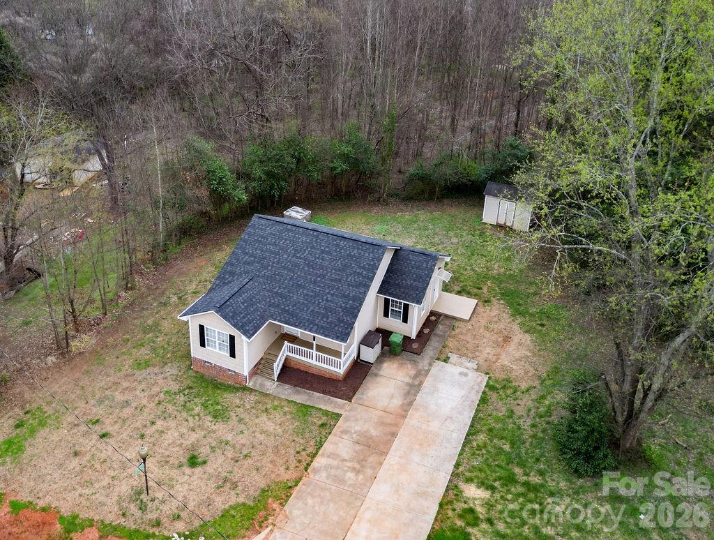226 B Brookwood Road Belmont, NC 28012 - Photo 3 of 29 a wooden bench sitting in the middle of a forest