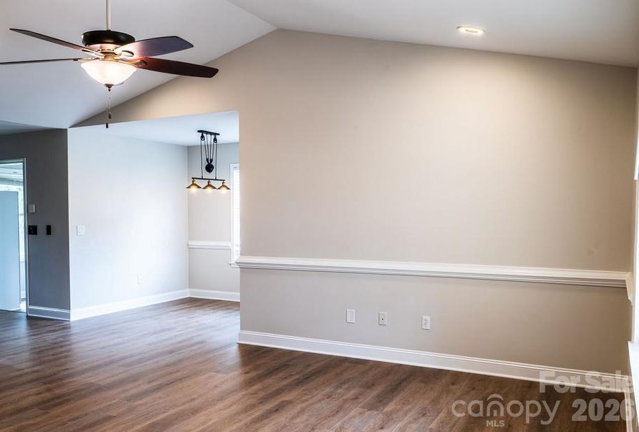 226 B Brookwood Road Belmont, NC 28012 - Photo 7 of 29 an empty room with wooden floor ceiling fan and window