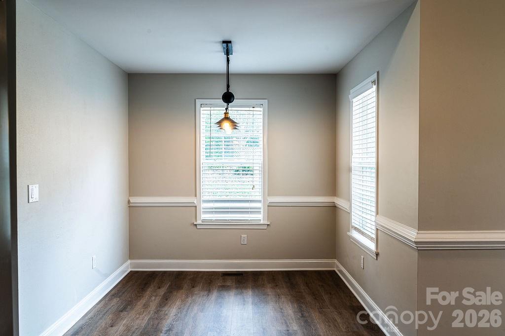 226 B Brookwood Road Belmont, NC 28012 - Photo 9 of 29 a view of an empty room with wooden floor and a window