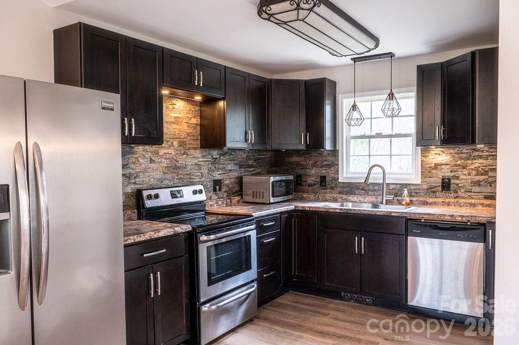 226 B Brookwood Road Belmont, NC 28012 - Photo 10 of 29 a kitchen with stainless steel appliances granite countertop a stove a sink and a refrigerator