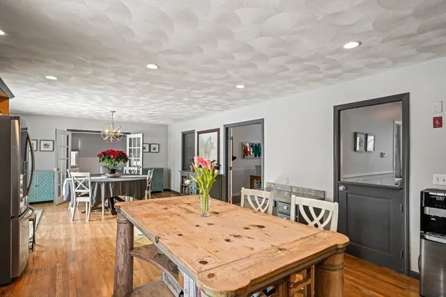 a living room with stainless steel appliances furniture and kitchen view