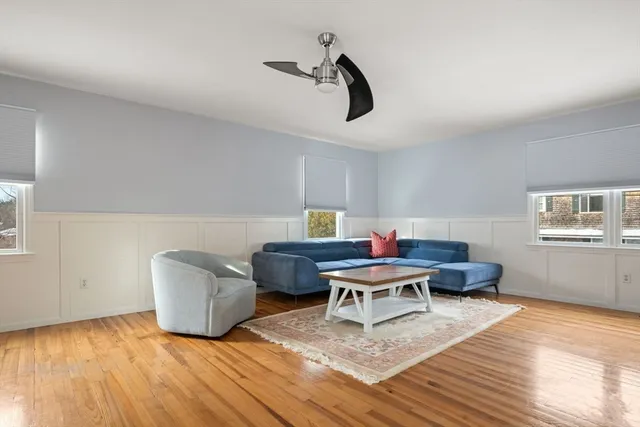 a living room with furniture and a wooden floor