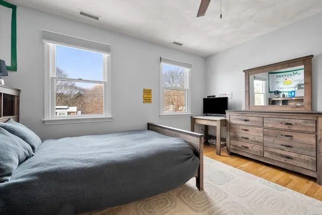 a bathroom with a granite countertop sink a toilet and a mirror