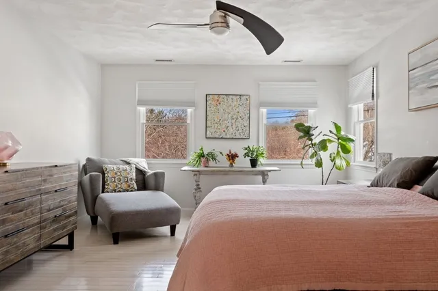 a spacious bathroom with a granite countertop sink a mirror and a bathtub