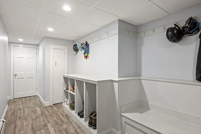 a large white kitchen with wooden floor and a sink