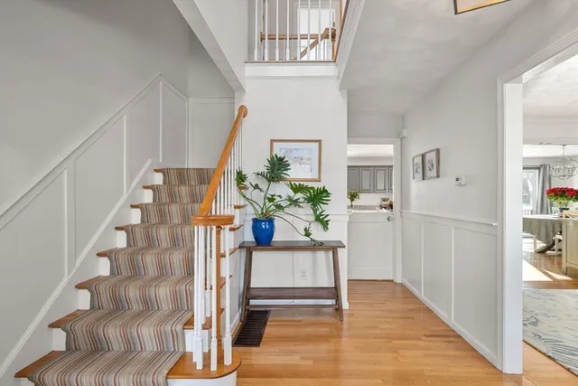 a view of entryway and hall with wooden floor
