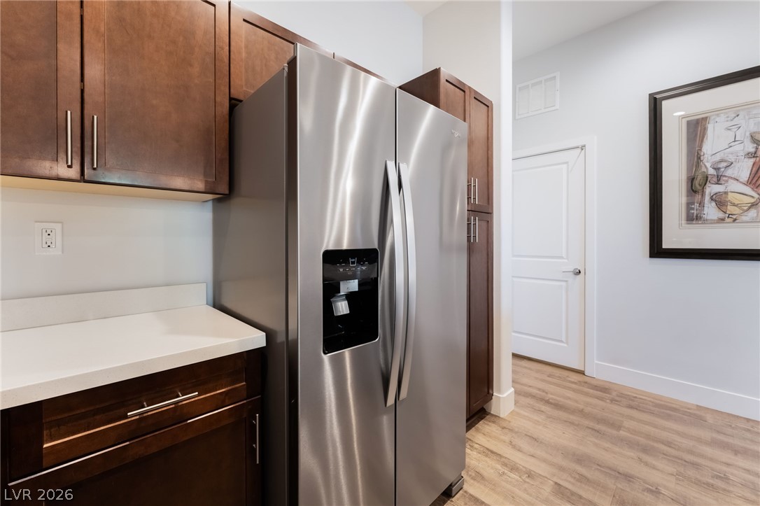 6432 Spring Jog Street Las Vegas, NV 89166 - Photo 14 of 61 A sleek stainless steel refrigerator seamlessly integrated into a modern kitchen setting.