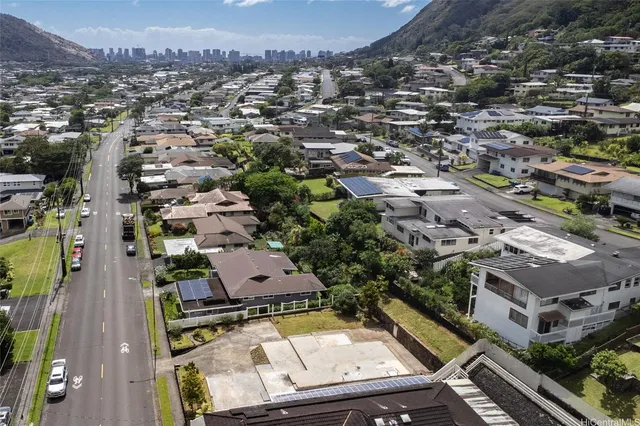 an aerial view of residential houses with city view