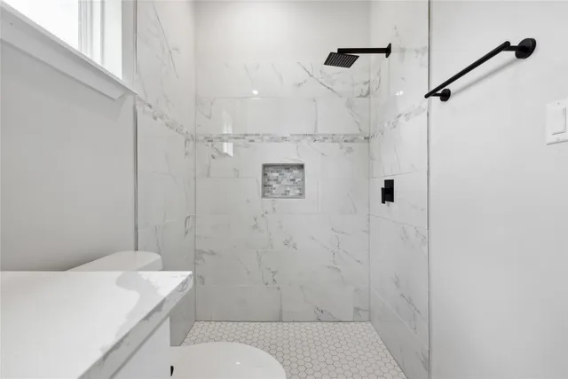 a bathroom with a sink toilet and shower