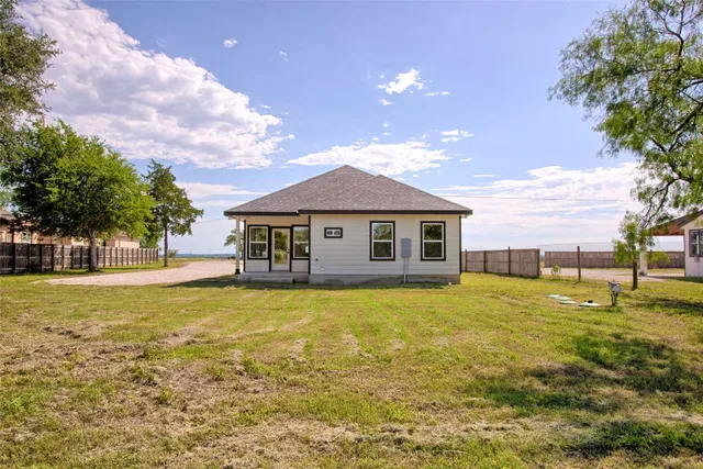 a view of yard with swimming pool and trees