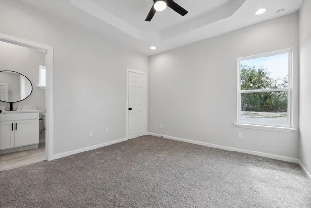 a view of a livingroom with a ceiling fan and window