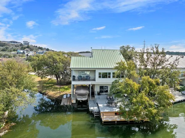 a view of a lake with a house swimming pool and outdoor space