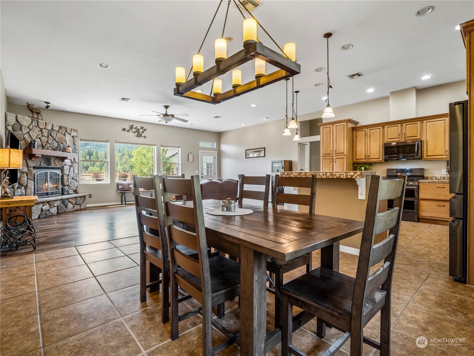 470 Old Cedars Road Cle Elum, WA 98922 - Photo 5 of 25 a dining room with stainless steel appliances lots of wooden furniture