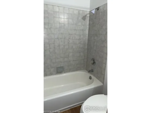 a bathroom with a bathtub and a toilet
