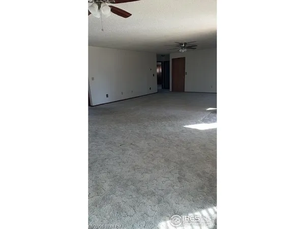 a view of a room with a ceiling fan