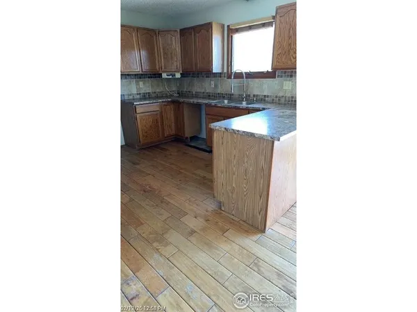 a kitchen with granite countertop a sink and a stove