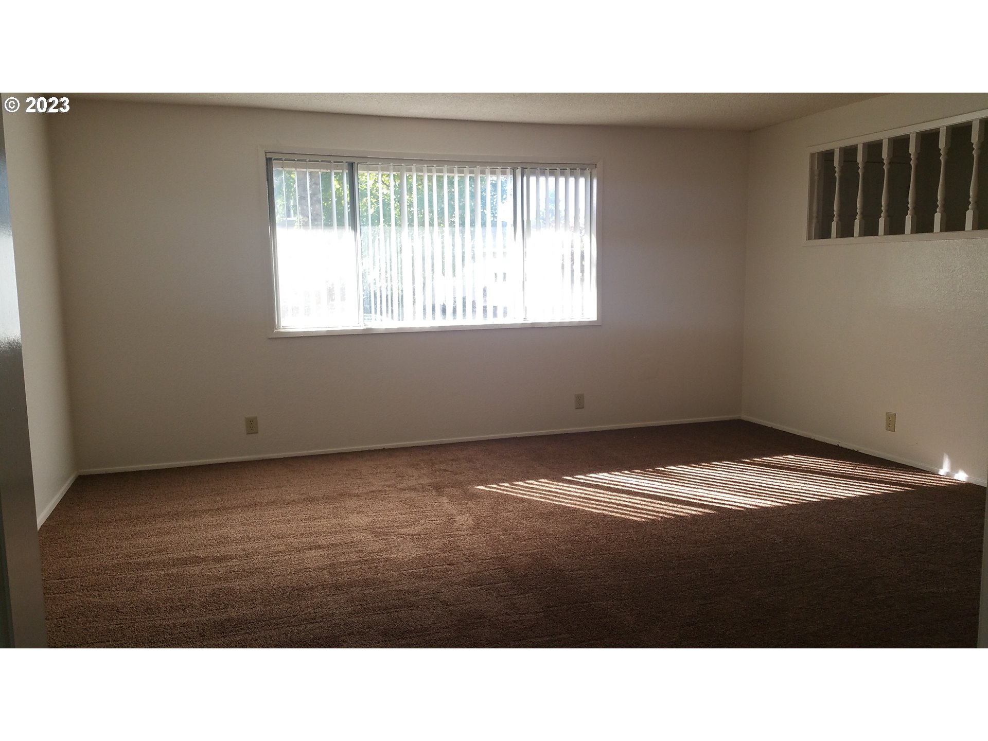806 V Street Springfield, OR 97477 - Photo 12 of 14 a view of an empty room with wooden floor and a window