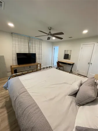 a bedroom with a bed and a flat screen tv