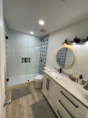 a bathroom with a sink toilet and shower
