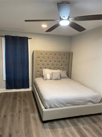 a bedroom with a bed and a lamp on table