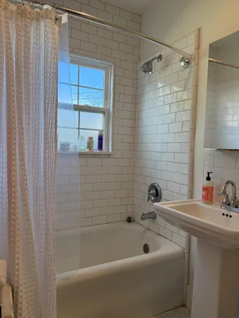 a bathroom with a sink a mirror and shower