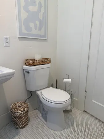 a white toilet sitting next to a bathroom sink