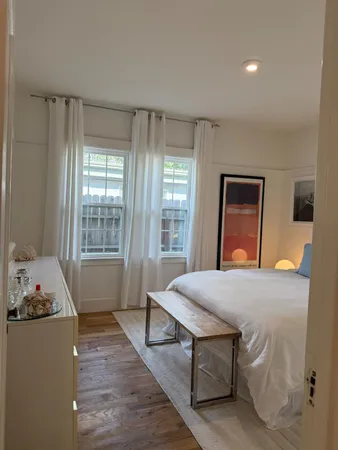 a bedroom with a large bed and a window