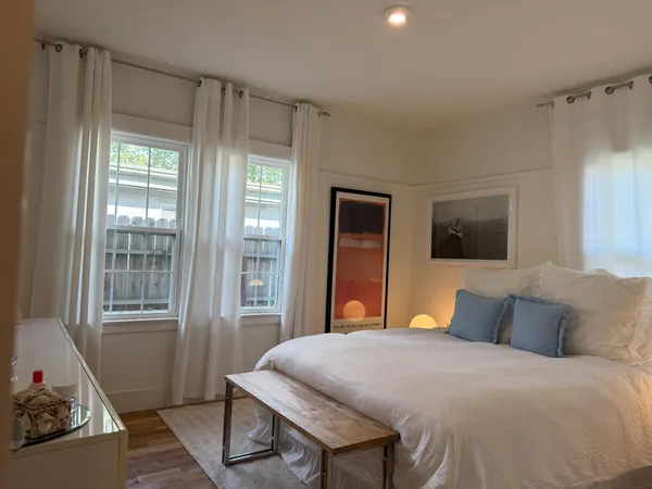 a bedroom with a bed table and chair