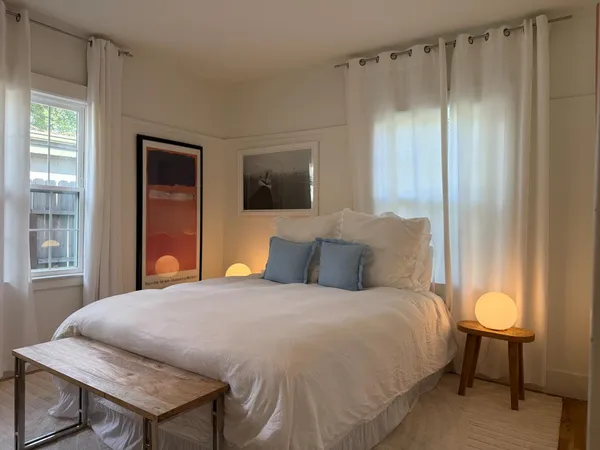 a bedroom with a large bed and a tv