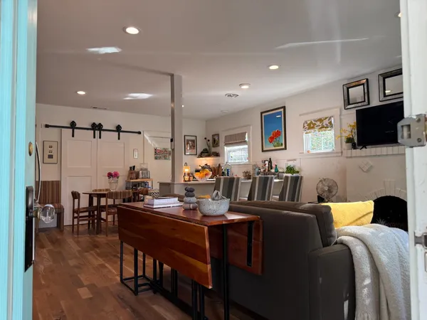 a view of a house with brick walls and a large tree