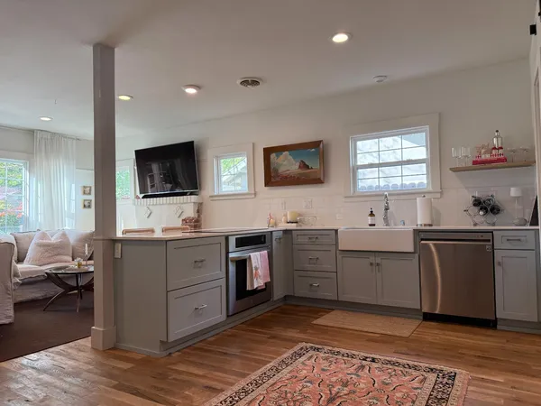 a kitchen with a sink cabinets and wooden floor