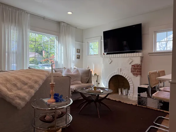 a living room with furniture flat screen tv and a fireplace