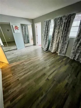 a view of an empty room and wooden floor