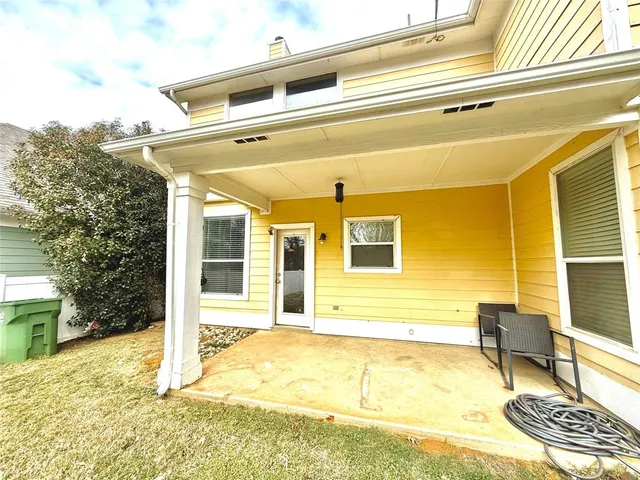 a view of a house with a swimming pool and sitting area