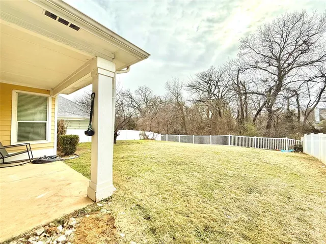 a swimming pool with outdoor seating and yard