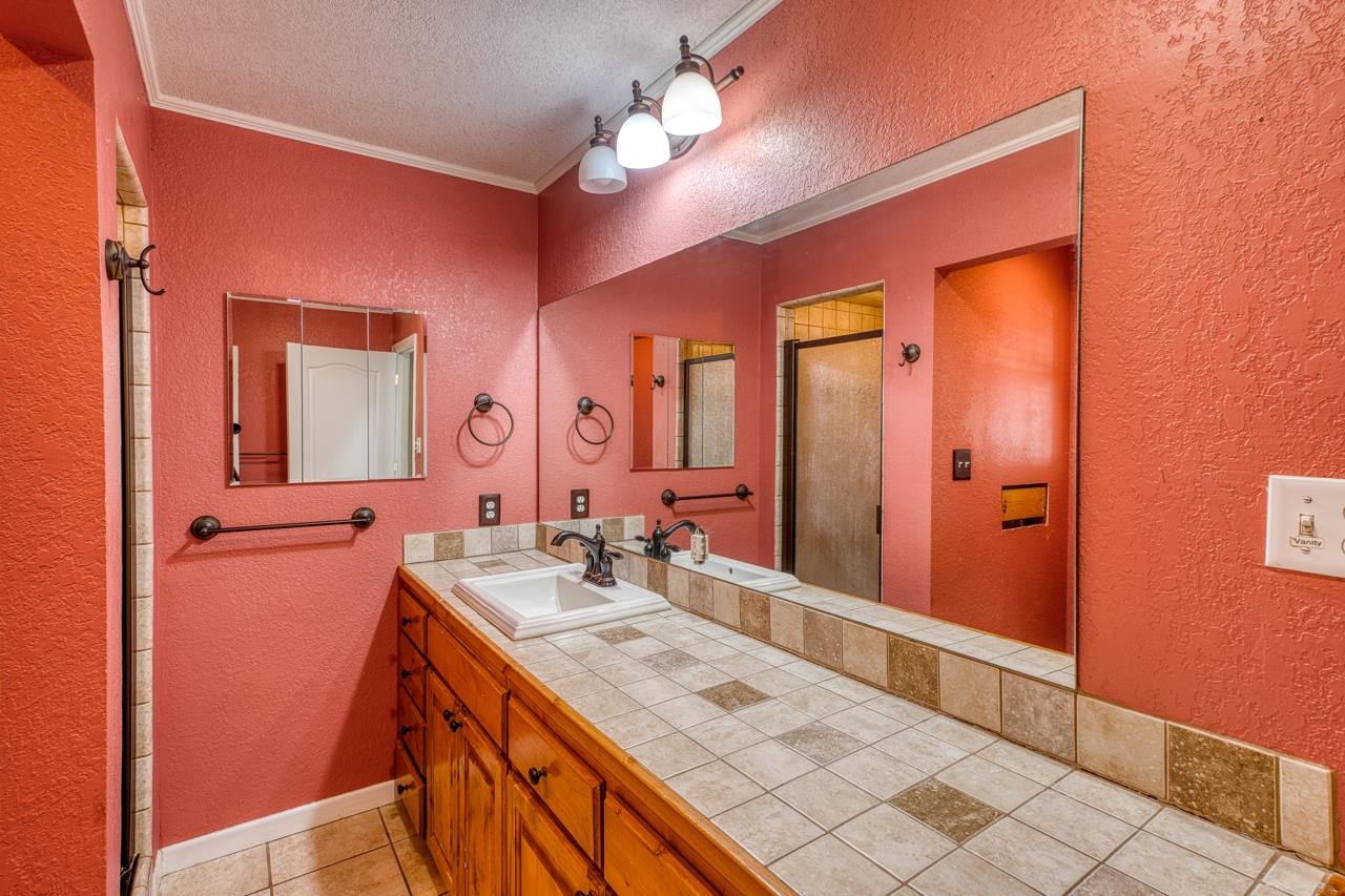 207 Princess Terrace Sunrise Beach, TX 78643 - Photo 12 of 25 a bathroom with a sink vanity and a mirror