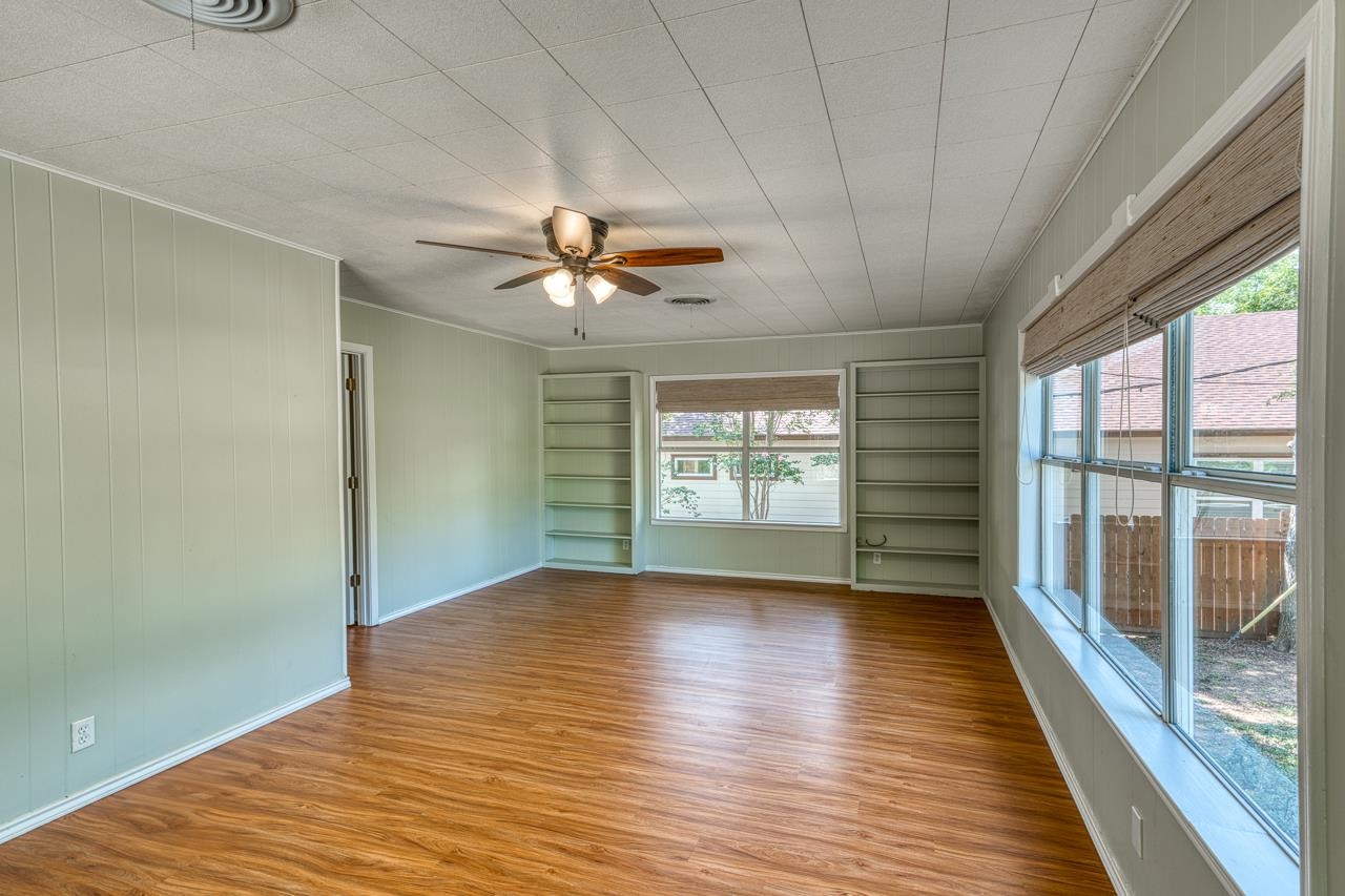 207 Princess Terrace Sunrise Beach, TX 78643 - Photo 16 of 25 a view of an empty room with a window and wooden floor