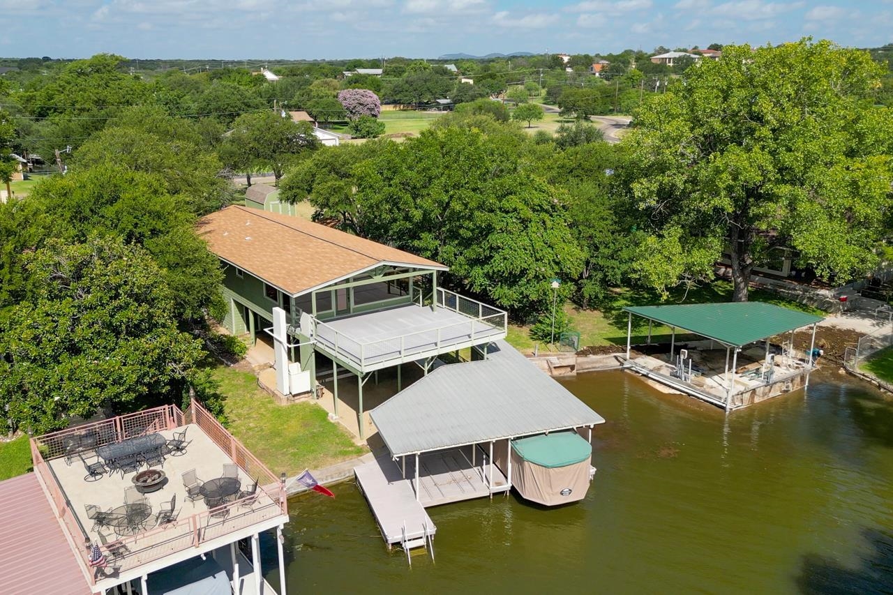 207 Princess Terrace Sunrise Beach, TX 78643 - Photo 2 of 25 an aerial view of a house with swimming pool garden and lake view