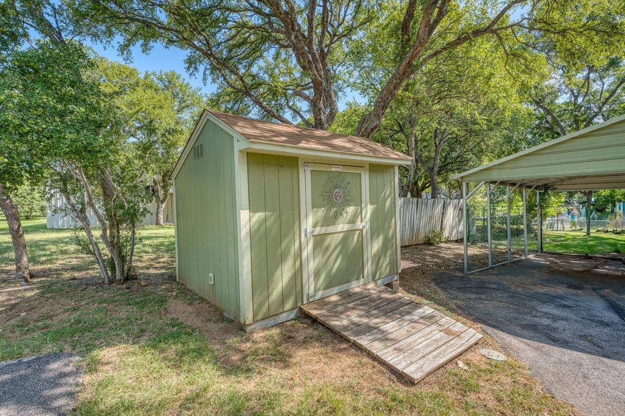 207 Princess Terrace Sunrise Beach, TX 78643 - Photo 22 of 25 a view of a backyard with a tree