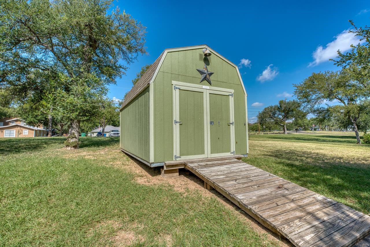 207 Princess Terrace Sunrise Beach, TX 78643 - Photo 24 of 25 a view of a tiny house with a yard