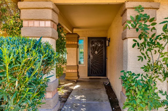 a couple of potted plants in front of door