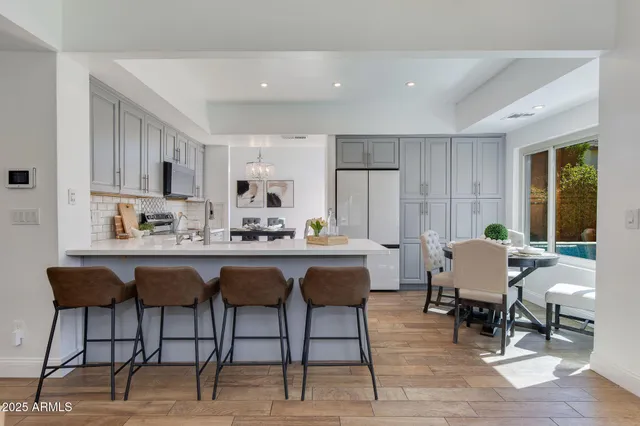 a bathroom with a granite countertop sink a toilet and mirror