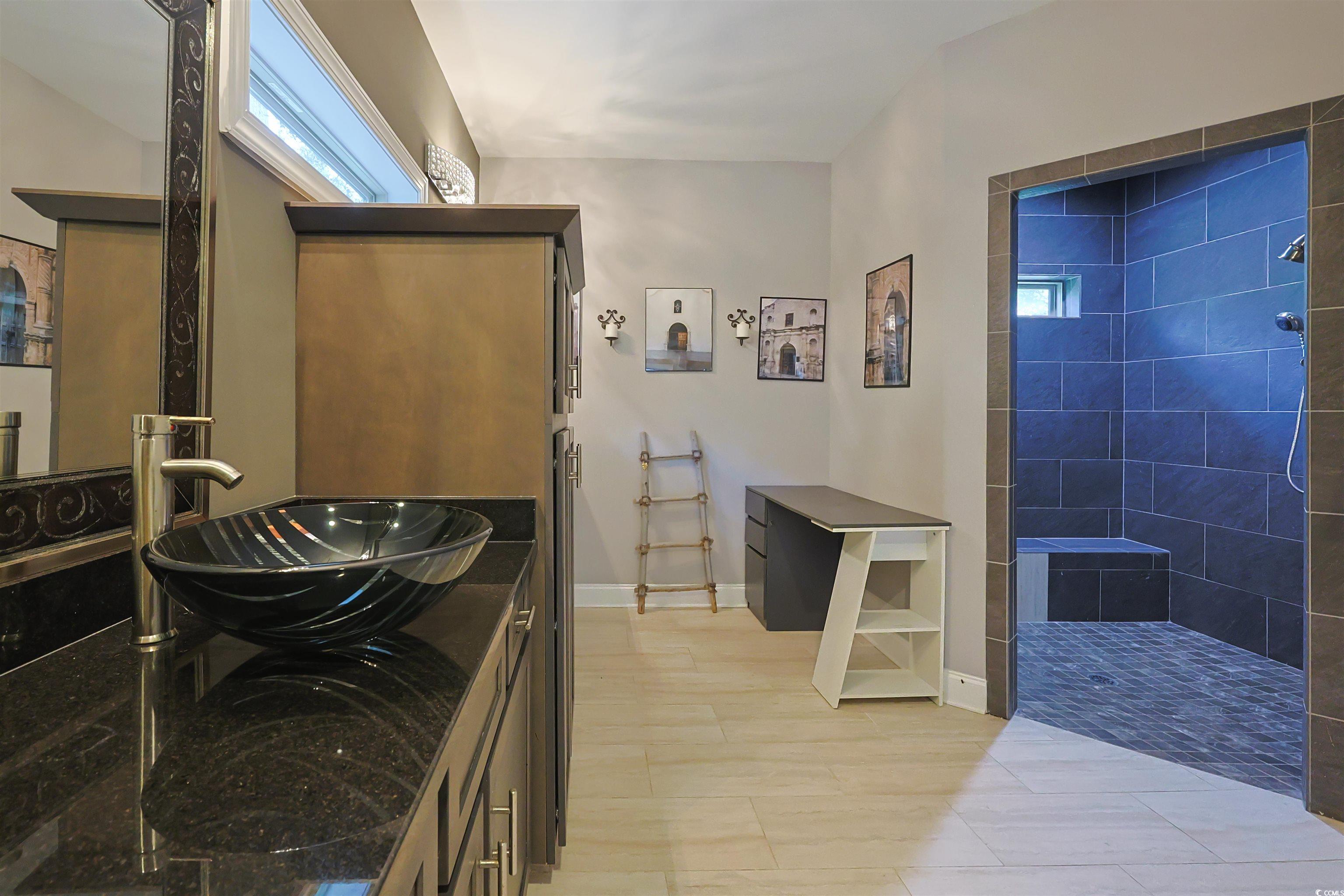 1065 Wigeon Drive Conway, SC 29526 - Photo 11 of 40 Bathroom with healthy amount of natural light, double vanity, tiled shower, and light tile patterned flooring