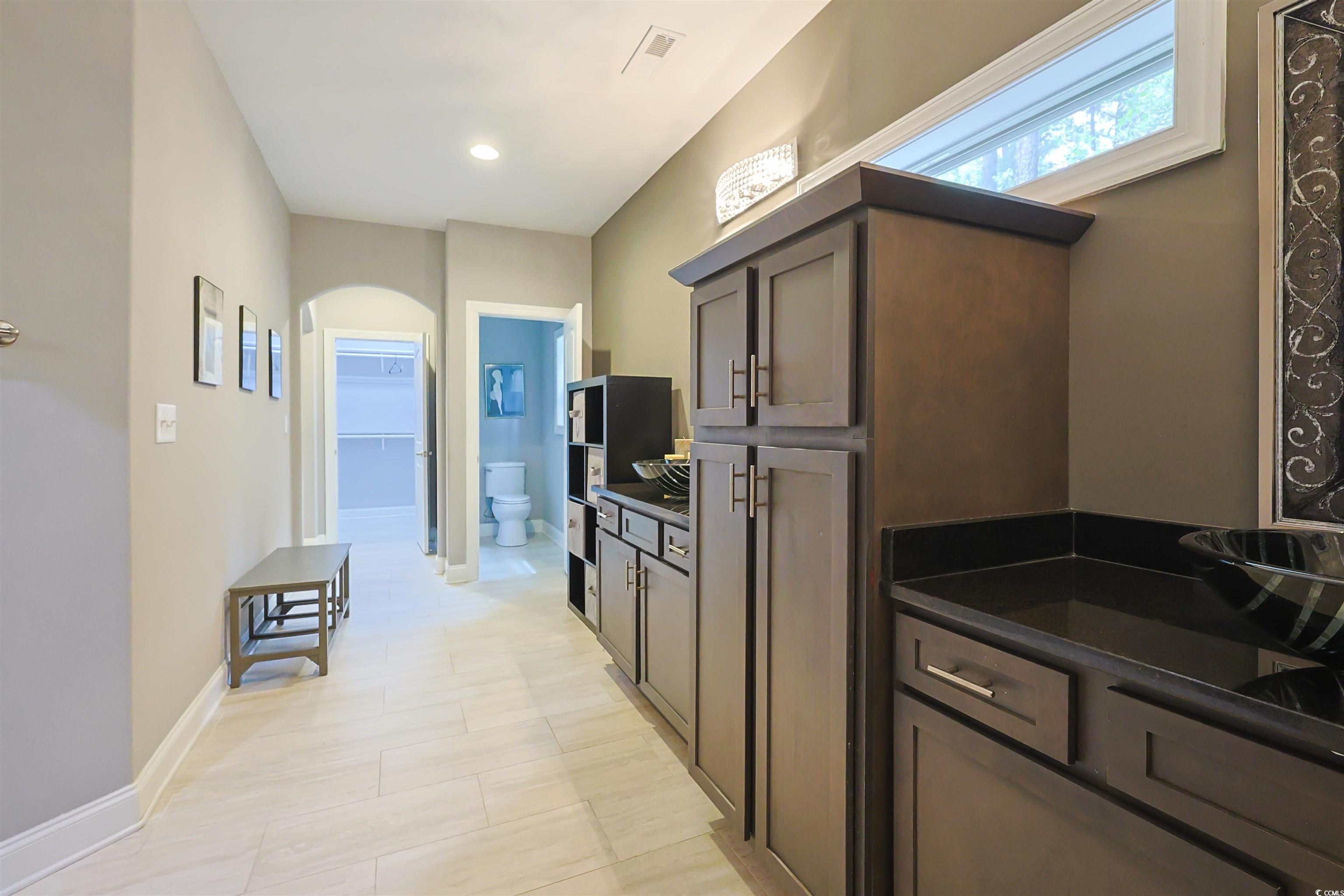 1065 Wigeon Drive Conway, SC 29526 - Photo 12 of 40 Kitchen featuring arched walkways, dark brown cabinets, and recessed lighting